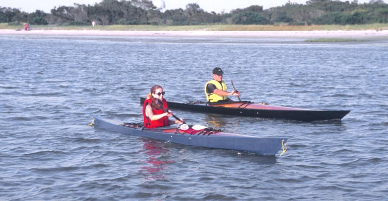 A couple paddling Chesapeake 14 (foreground) and Chesapeake 18 wooden kayaks