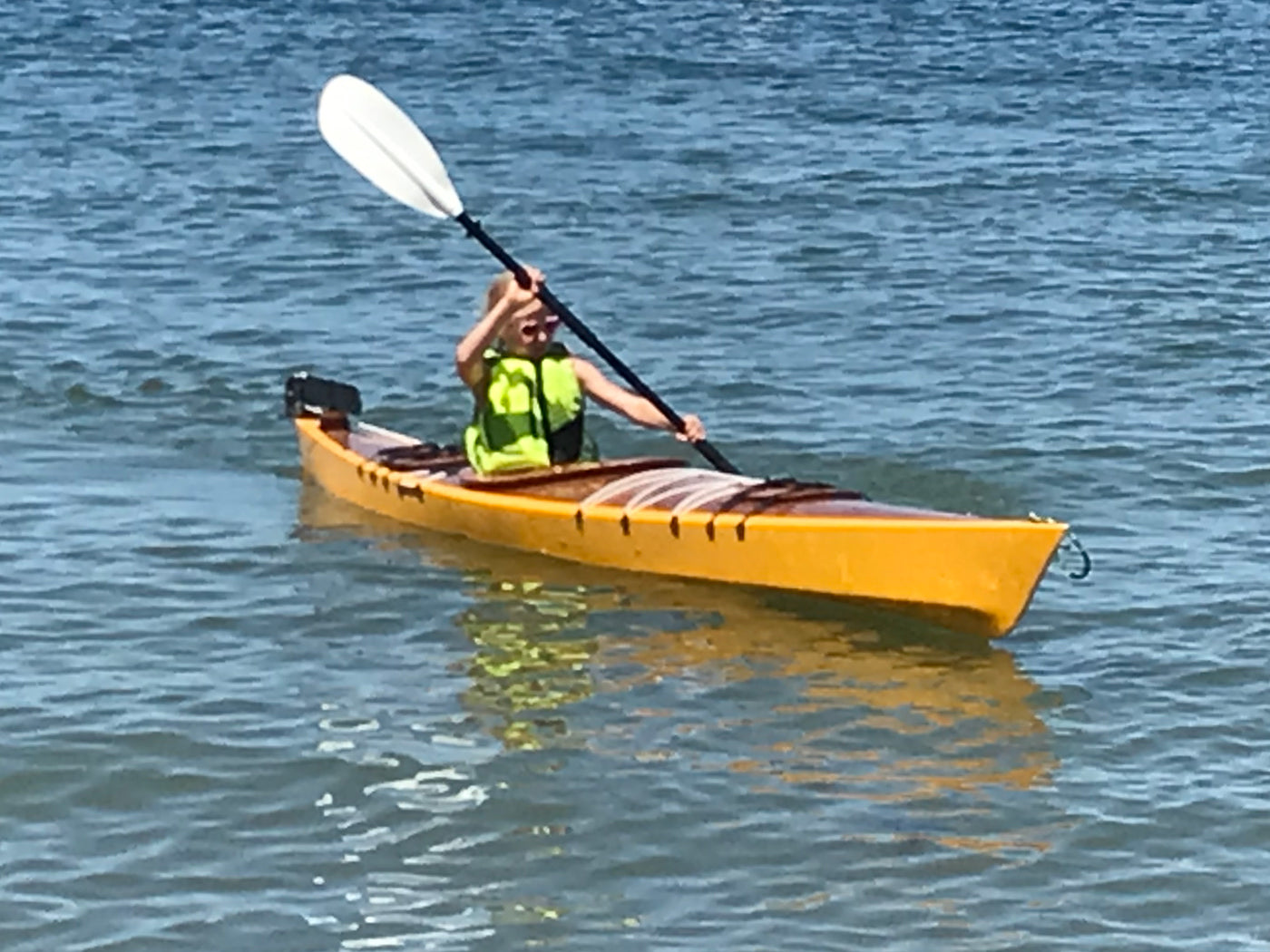 A young paddler in a Chesapeake 14 wooden kayak built by Tony O.