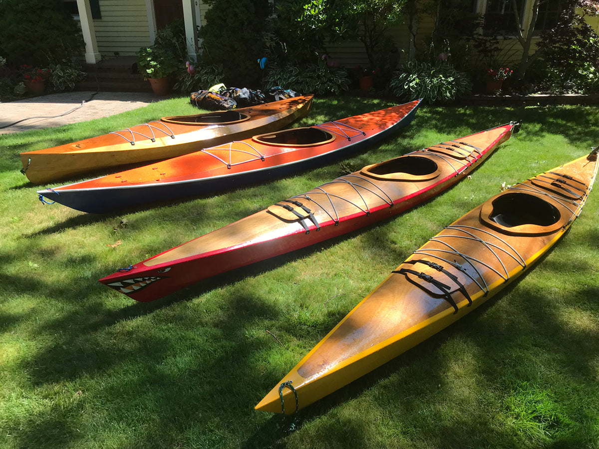 A lineup of wooden kayaks by Tony O., Cape Elizabeth, ME: Wood Duck 14, Shearwater Sport, Chesapeake 14, and Chesapeake 16LT (left to right)