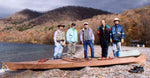 A group with a beached Chesapeake 14 wooden kayak built by Yanai T. in Japan Thumbnail