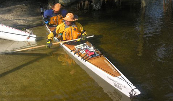 Two men competing in the Everglades Challenge in a Chesapeake Sport Tandem wooden kayak