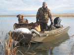 After a day spent hunting in his Cackler, 14, this hunter returns with his dog, decoys, and a dead swan. Thumbnail