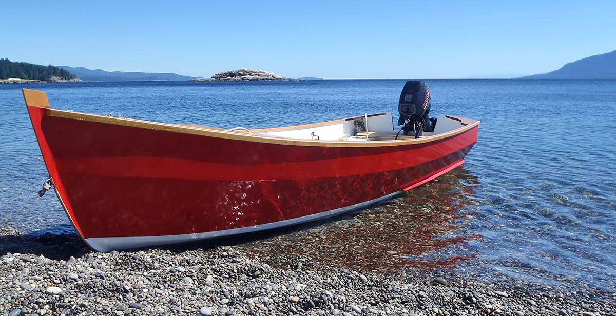 A sleek red Candlefish waits at the water's edge.