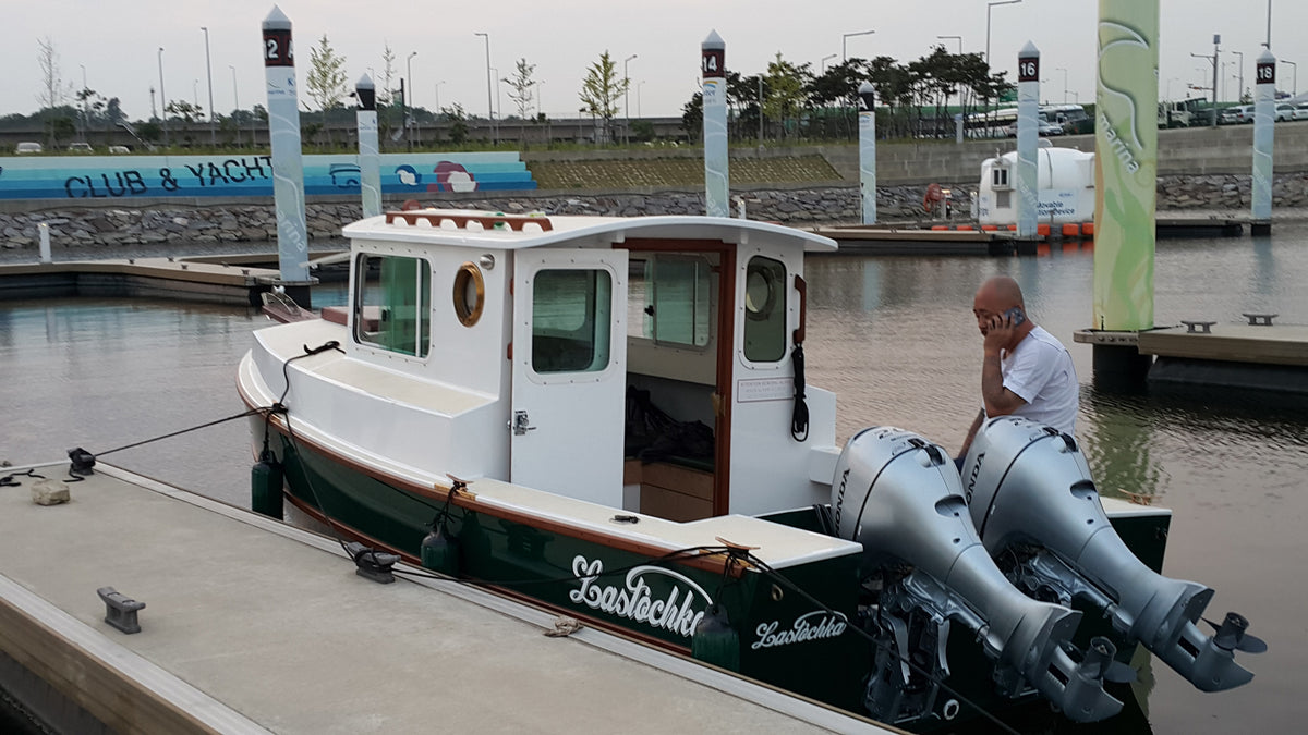 Dipper 19 with twin outboards, docked