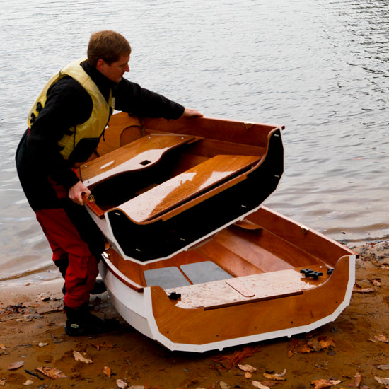 Eastport Nesting Pram's bow being placed into its nested position within the aft hull. 