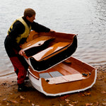 Eastport Nesting Pram's bow being placed into its nested position within the aft hull.  Thumbnail