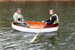 The joint on the Eastport Nesting Pram is clearly visible in this image of John Harris rowing with a friend. Thumbnail