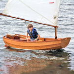A young sailor looks eagerly ahead for the helm of his Eastport Pram. Thumbnail