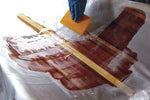 Plastic epoxy spreader being used on fiberglass. Thumbnail