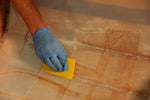 Plastic epoxy spreader being used to fill the fiberglass weave. Thumbnail