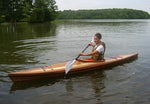 A woman paddling a Great Auk 14 sea kayak built by Dan G. Thumbnail