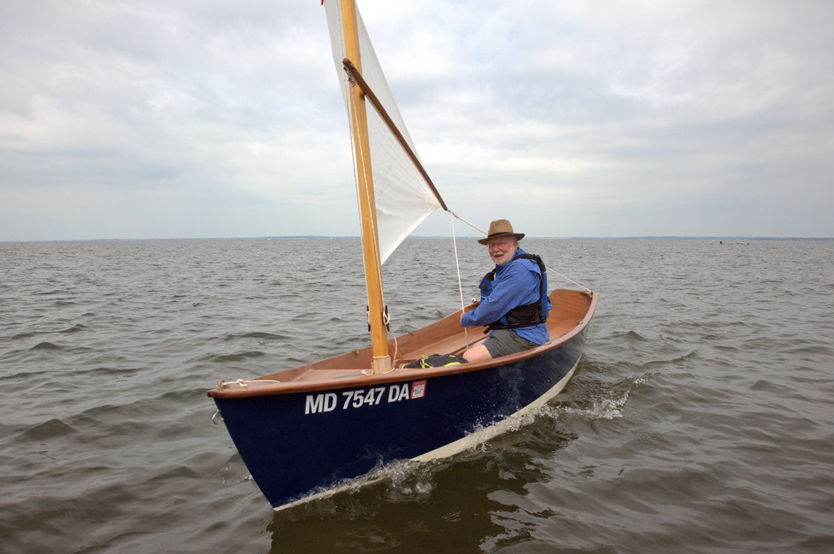 Terry Otis Sailing a Jimmy Skiff with a hat on, in the Chesapeake Bay. 