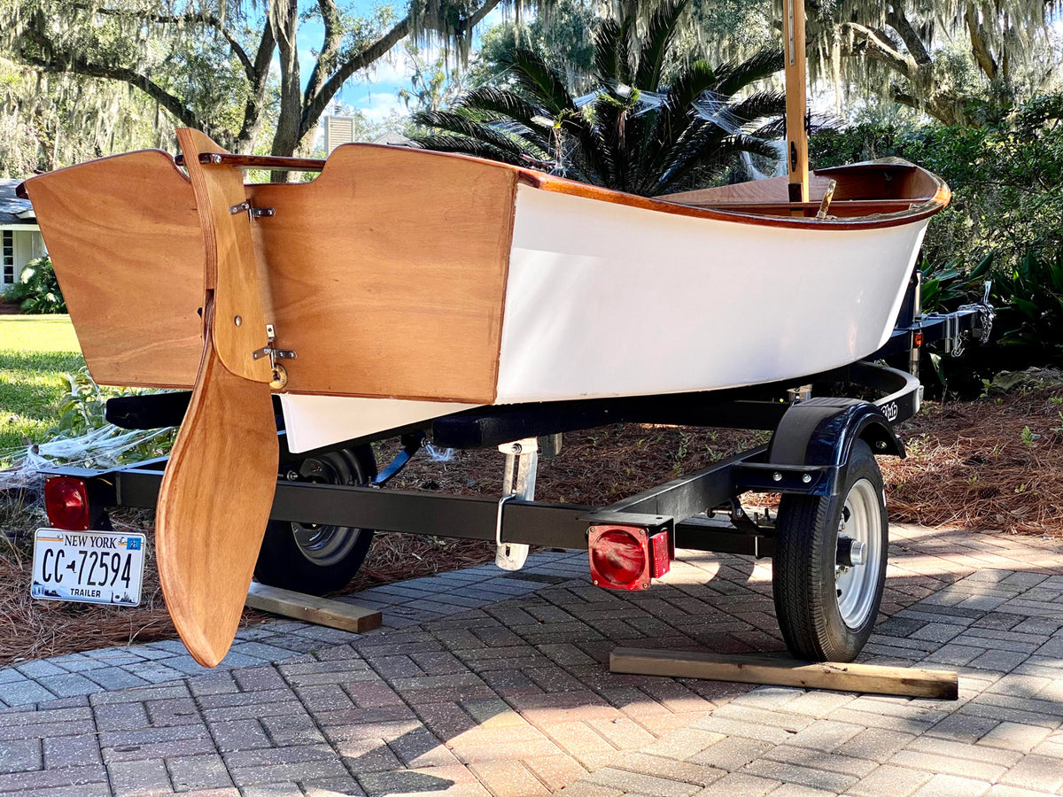 White hulled Jimmy Skiff on a trailer. 