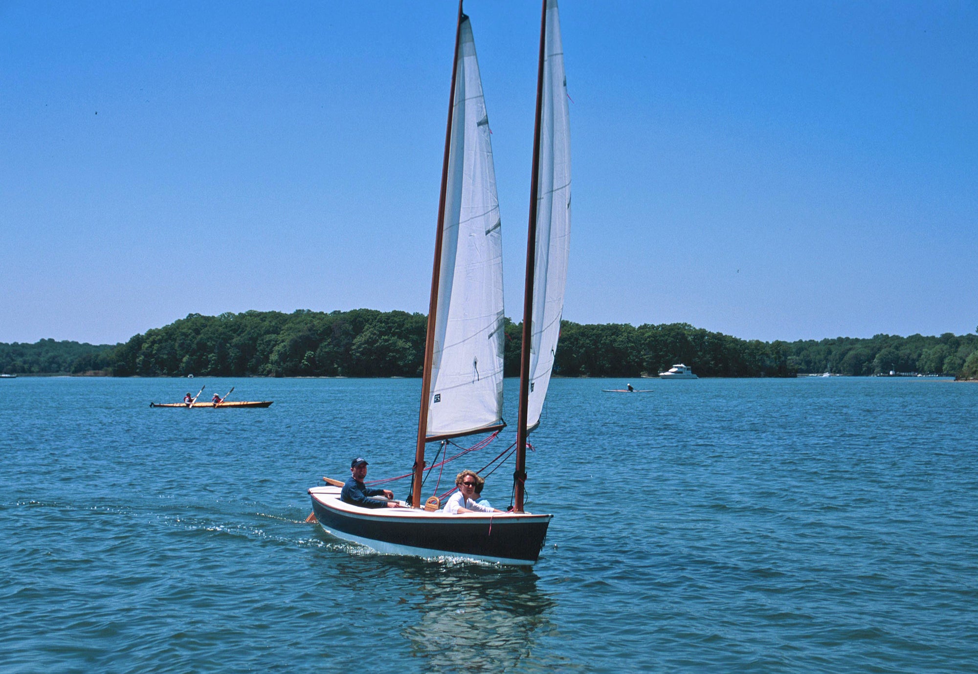 A crew of three enjoying a sail in their John's Sharpie on a gorgeous day.