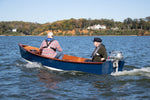 Jimmy Skiff with two men motoring using a 2-hp Honda outboard.  Thumbnail
