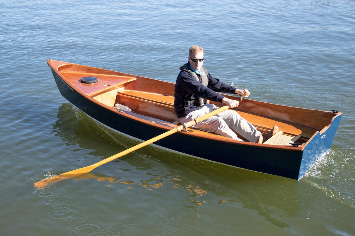 John Harris, CEO of Chesapeake Light Craft, showing off his rowing skills in his Jimmy Skiff II. His ultra-cool sunglasses and confident rowing posture augment the boat's beauty. 