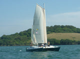 A Mana 24 catamaran under sail on a lovely day