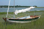 Passagemaker dinghy sailboat pulled into a tidal marsh Thumbnail