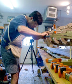 Designer Nick Schade stapling the first strips onto a Petrel Play kayak. Thumbnail