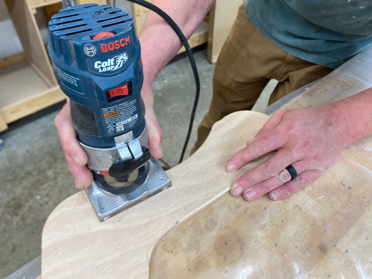 Using a router to round over the wood parts in the Rug Runner kit.