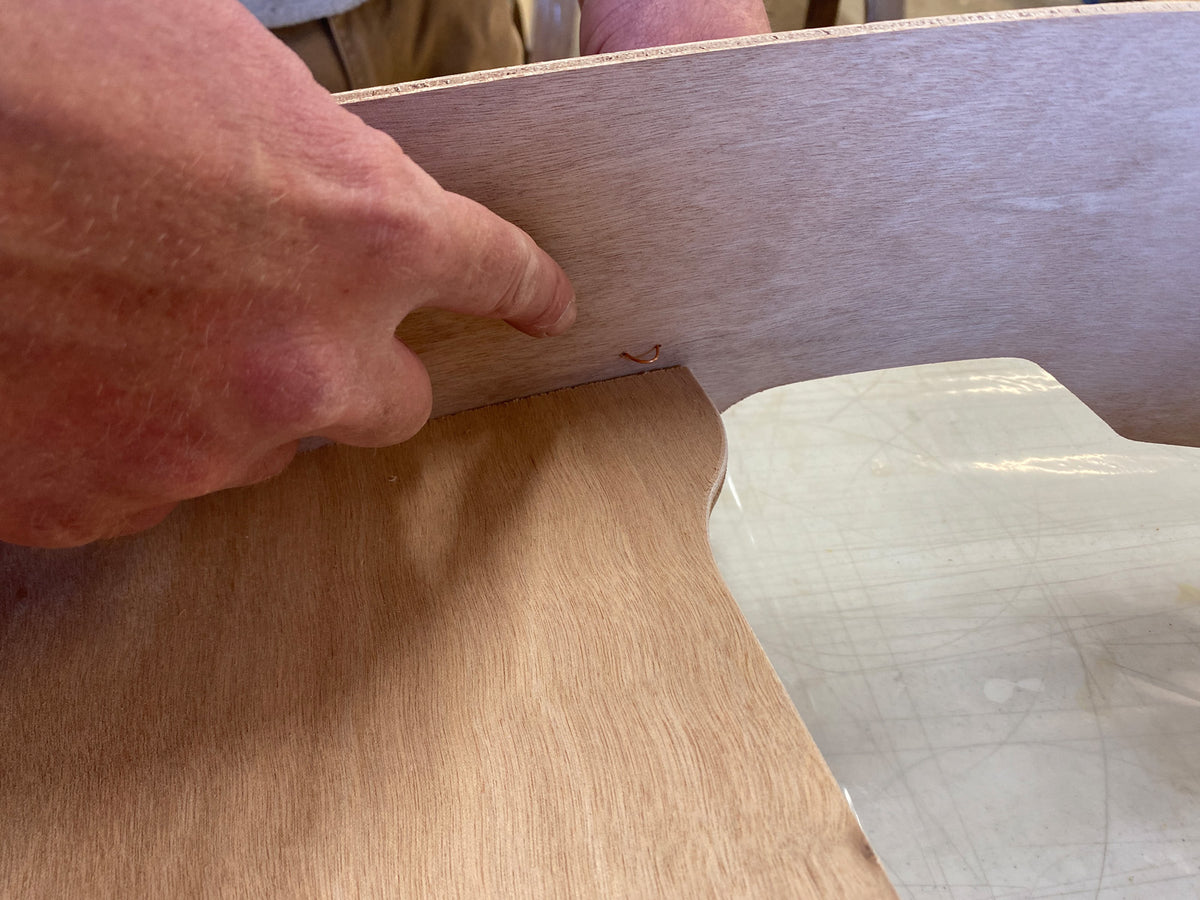 Bonding the seat of the Rug Runner kit to the hull panels and transom. 