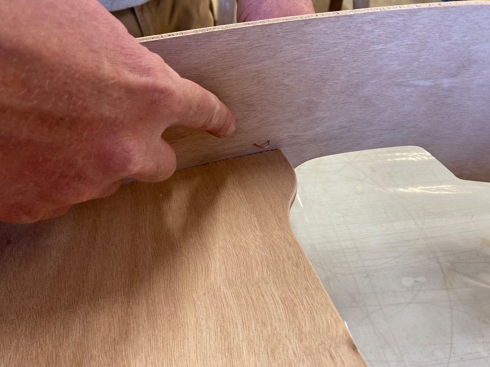 Bonding the seat of the Rug Runner kit to the hull panels and transom. 