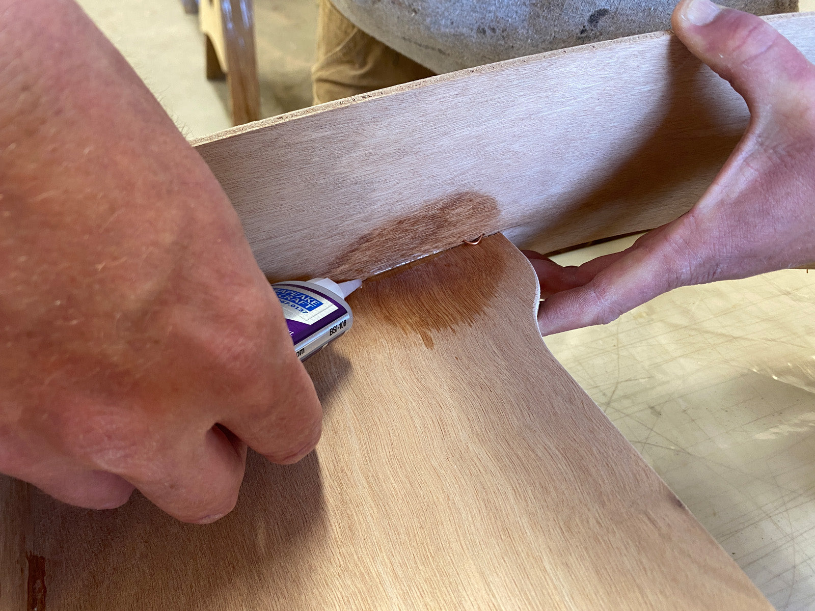 Bonding the seat of the Rug Runner kit to the hull panels and transom with CA Glue. 