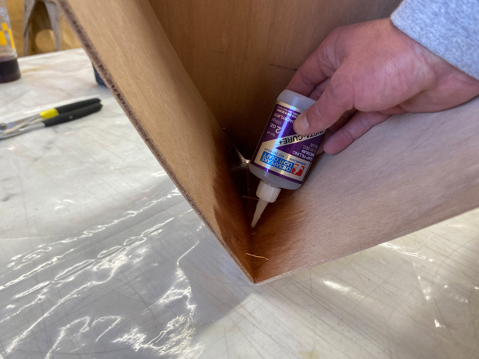 Bonding the foredeck of the Rug Runner kit to the hull panels with CA Glue.