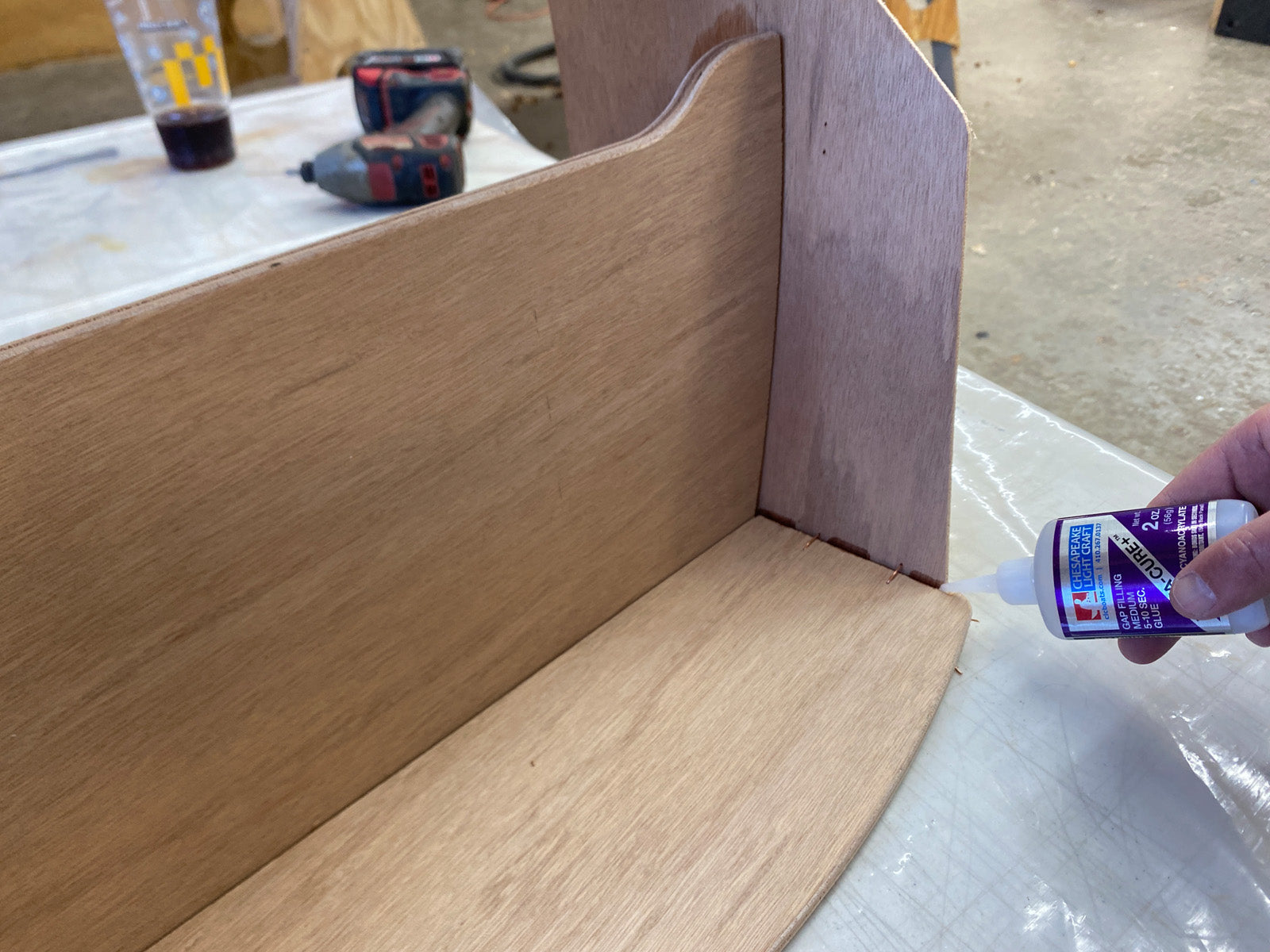Bonding the seat of the Rug Runner kit to the hull panels and transom. 