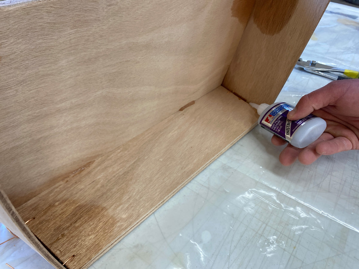 Bonding the seat of the Rug Runner kit to the hull panels and transom. 