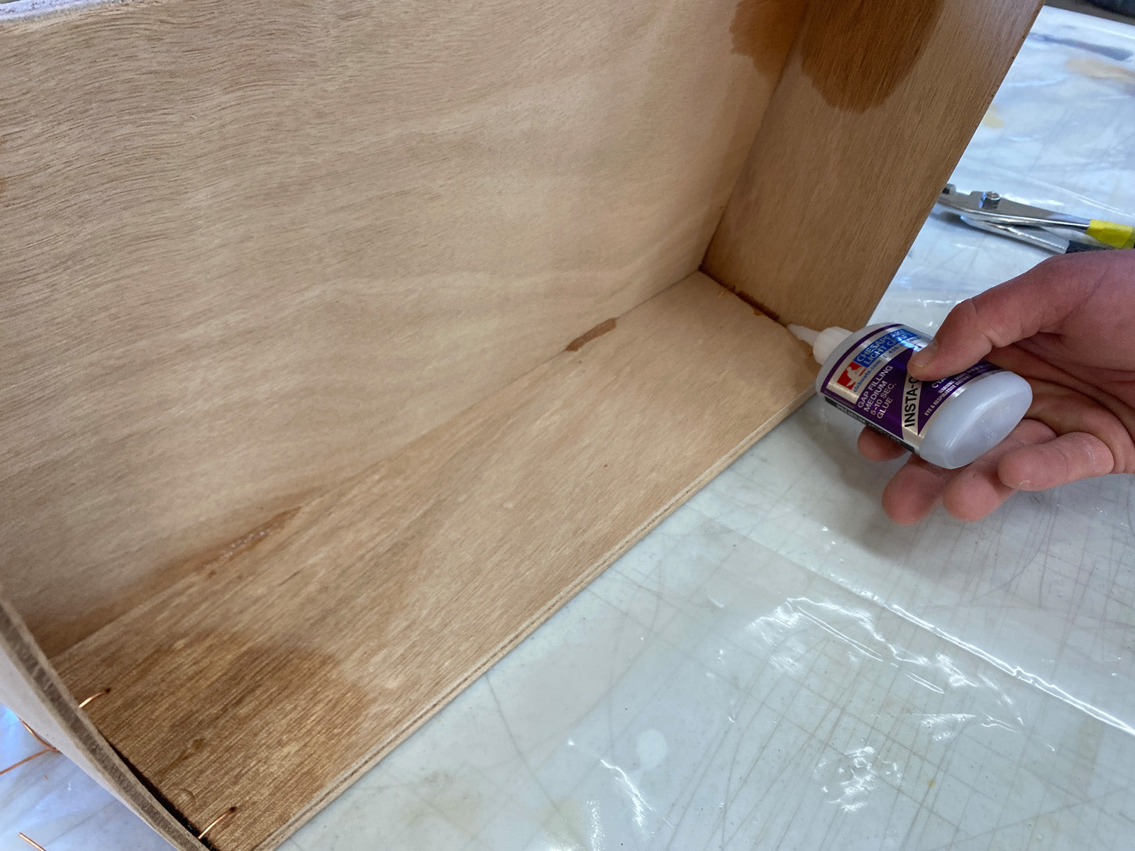 Bonding the seat of the Rug Runner kit to the hull panels and transom. 