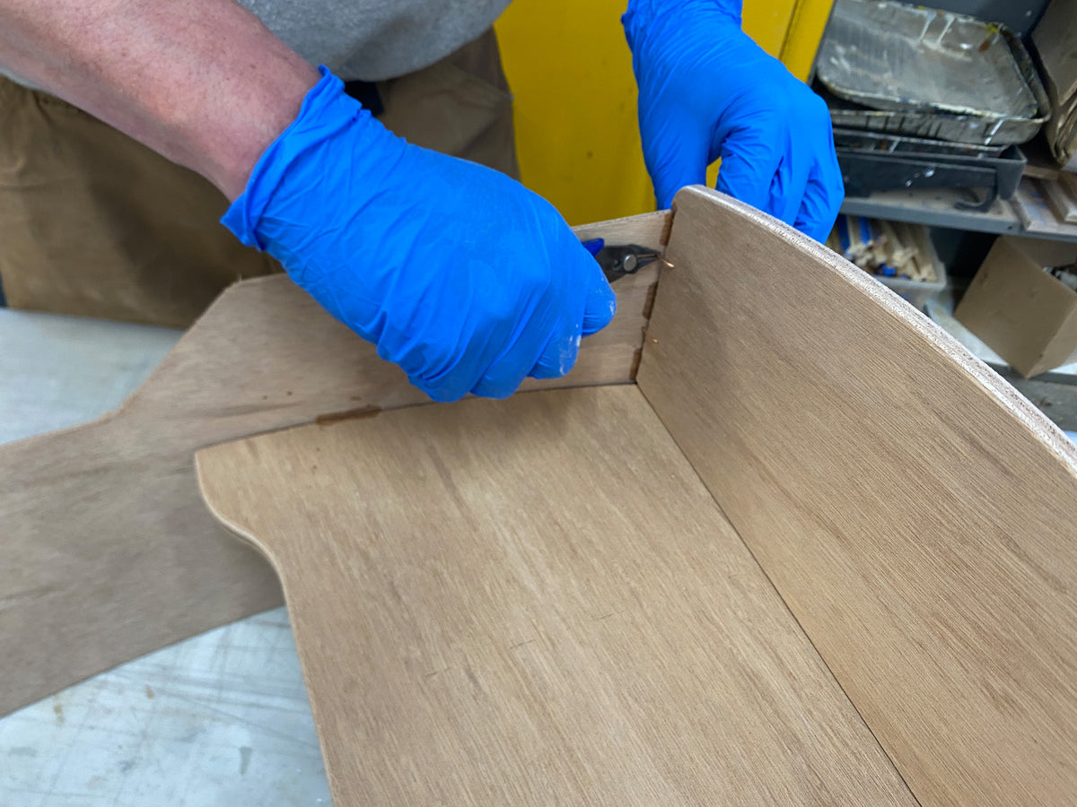 Removing the stitches in preparation for epoxy fillets.