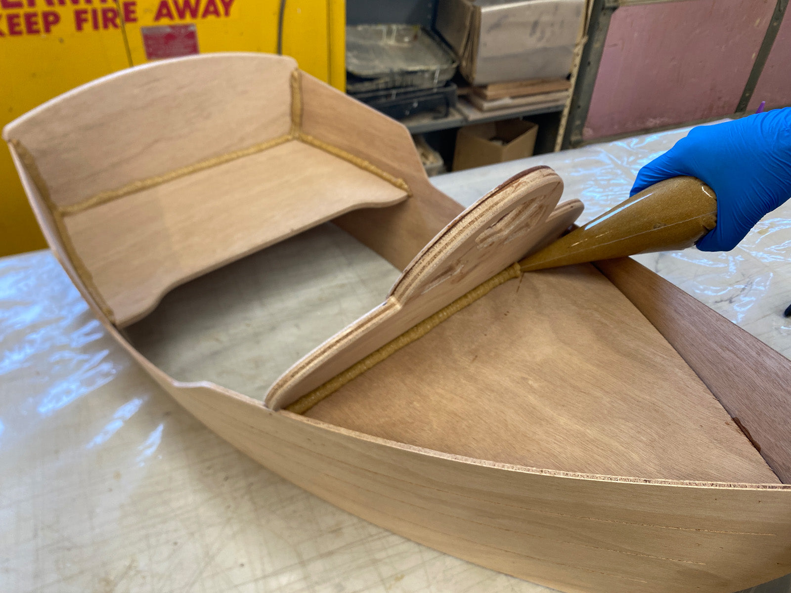 Applying epoxy fillets to enhance the bond of the wood parts.