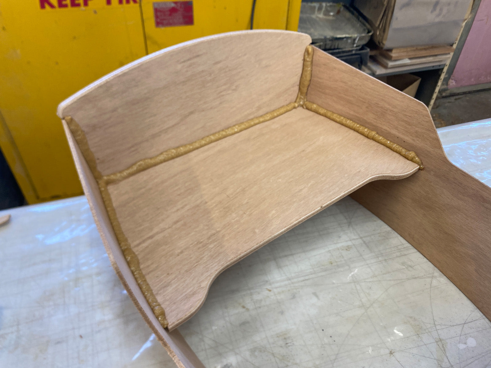 Applying epoxy fillets to enhance the bond of the wood parts.
