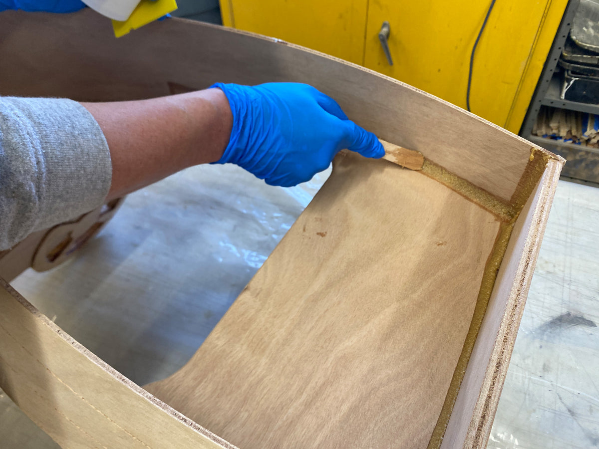 Using Fillet Sticks to smooth the epoxy fillets.
