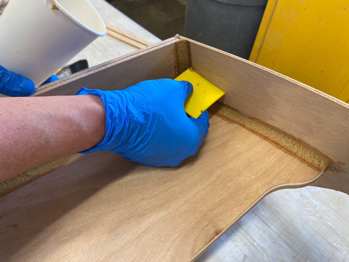 Cleaning up the excess epoxy from the fillets.