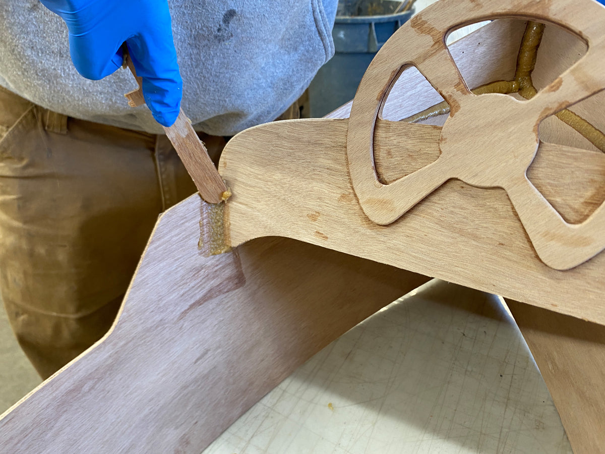 Using Fillet Sticks to smooth the epoxy fillets.