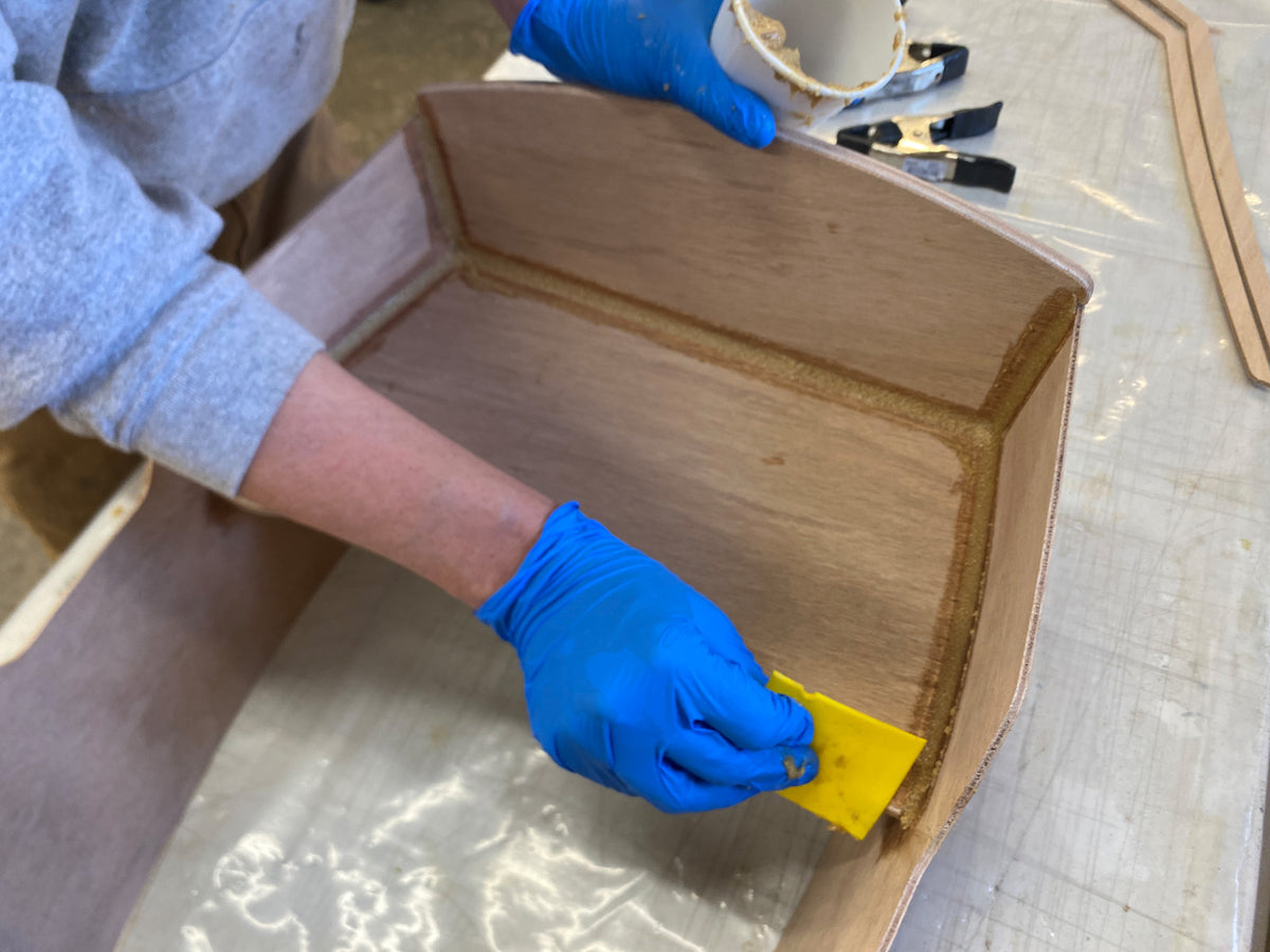 Cleaning up the excess epoxy from the fillets.