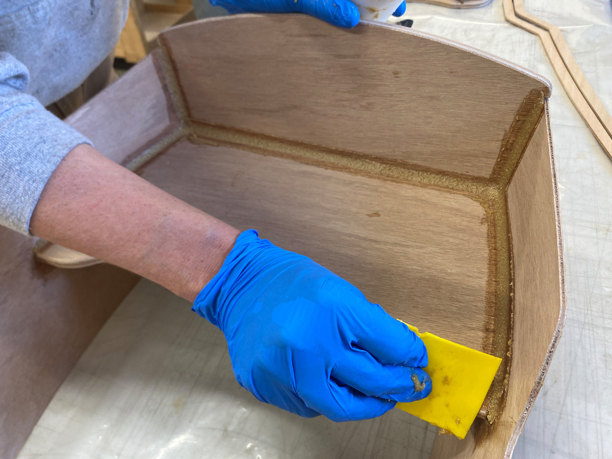 Cleaning up the excess epoxy from the fillets.