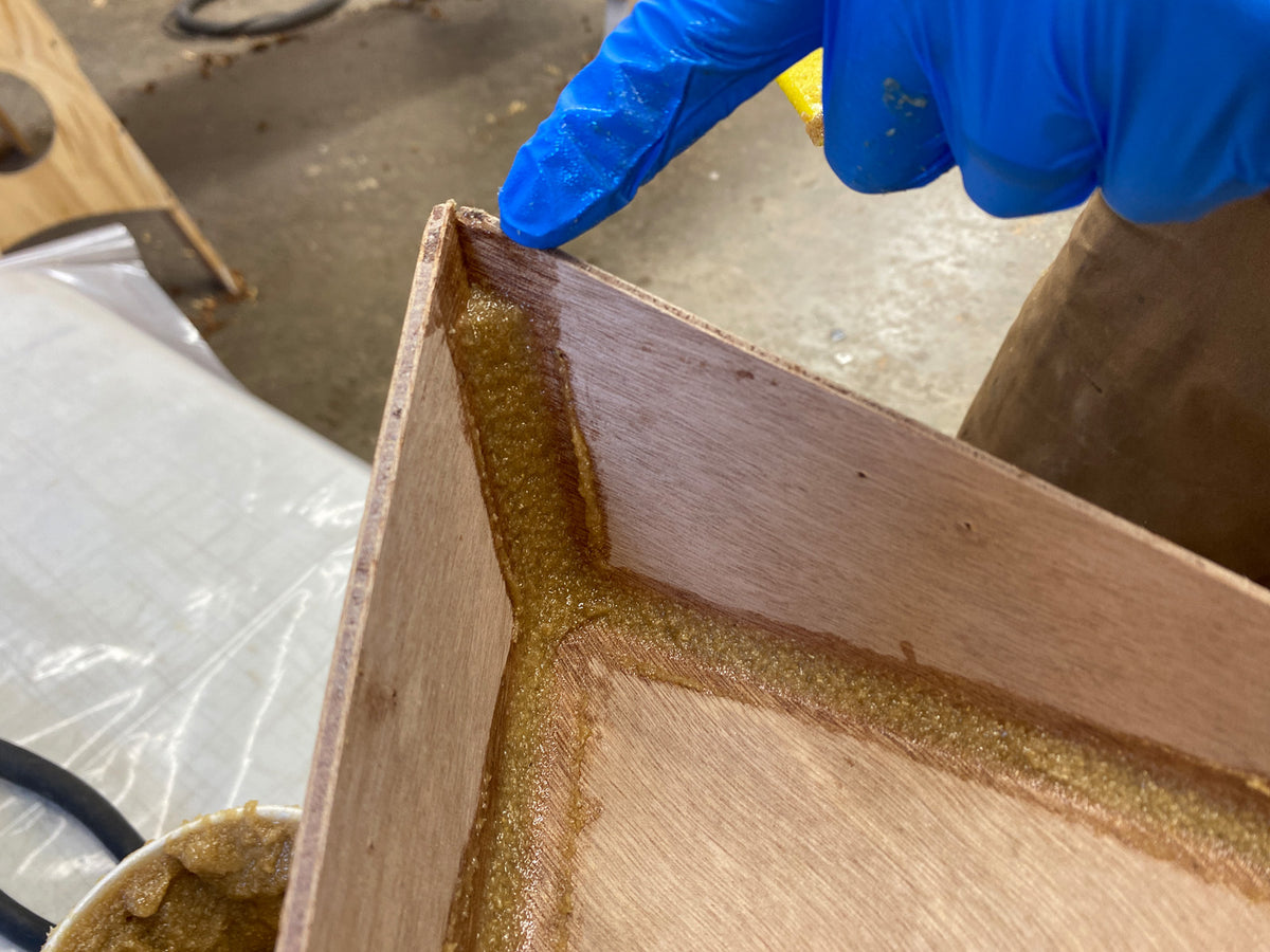 Cleaning up the excess epoxy from the fillets.