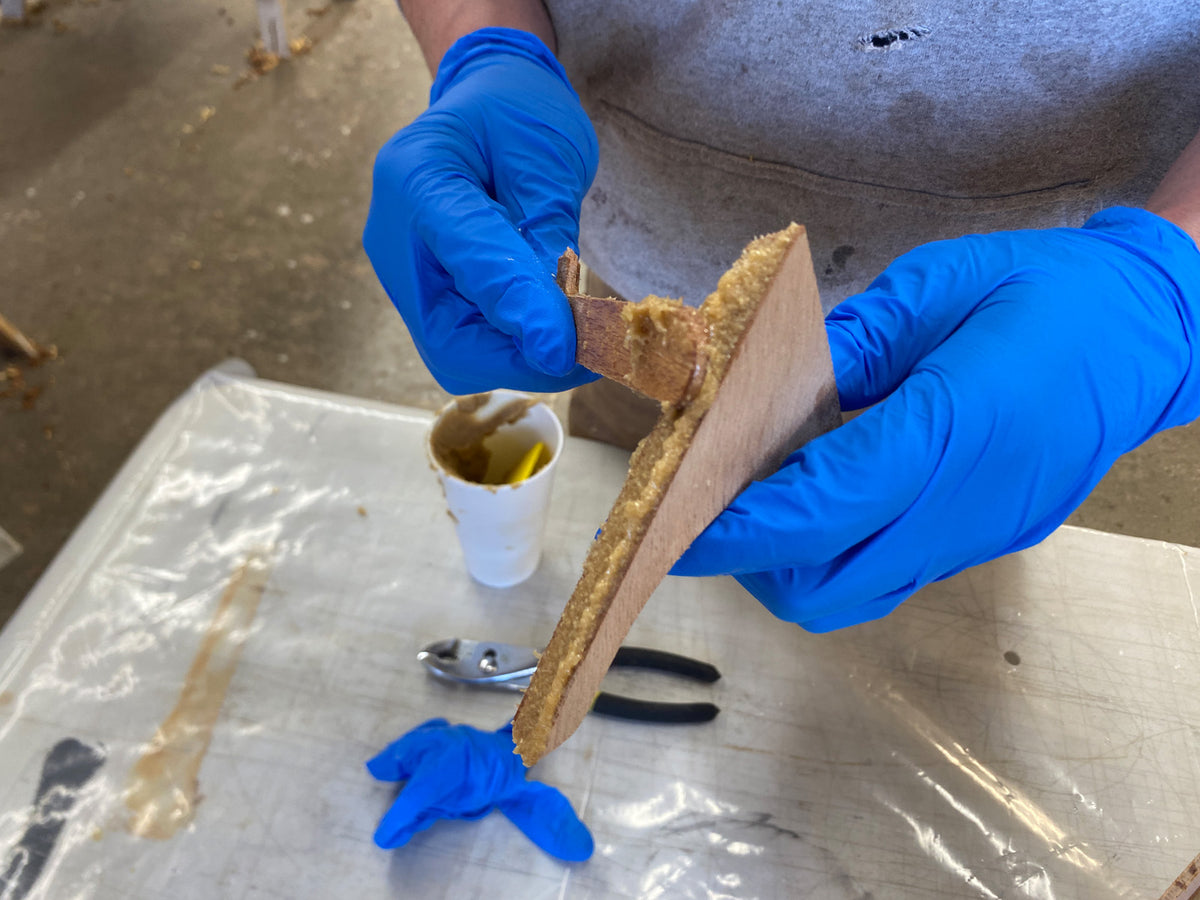 Applying epoxy to the breathook for installation.