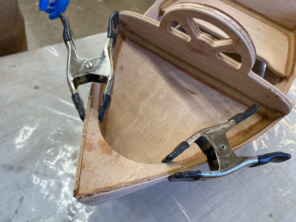 Bonding the breasthook to the bow parts.