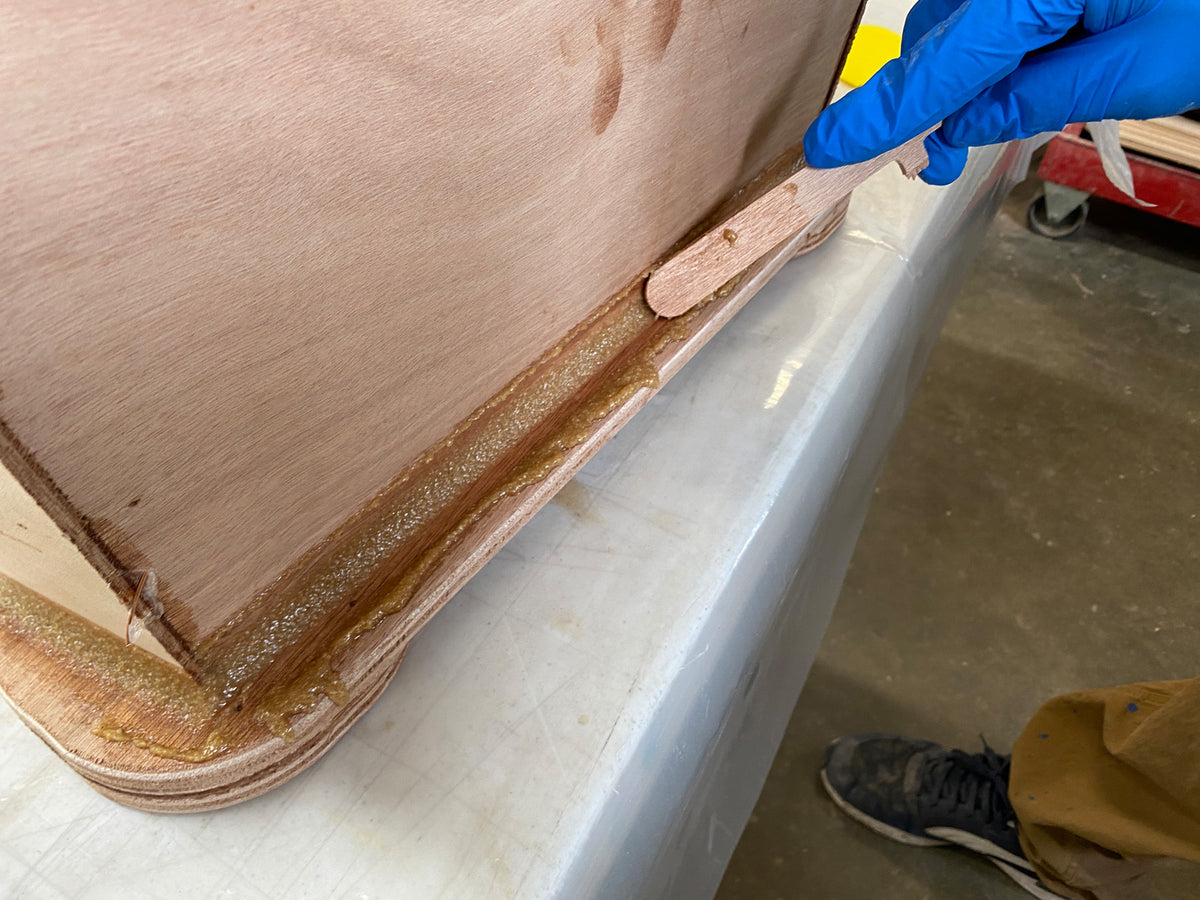 Smoothing the fillets on the caster mounts with fillet sticks.