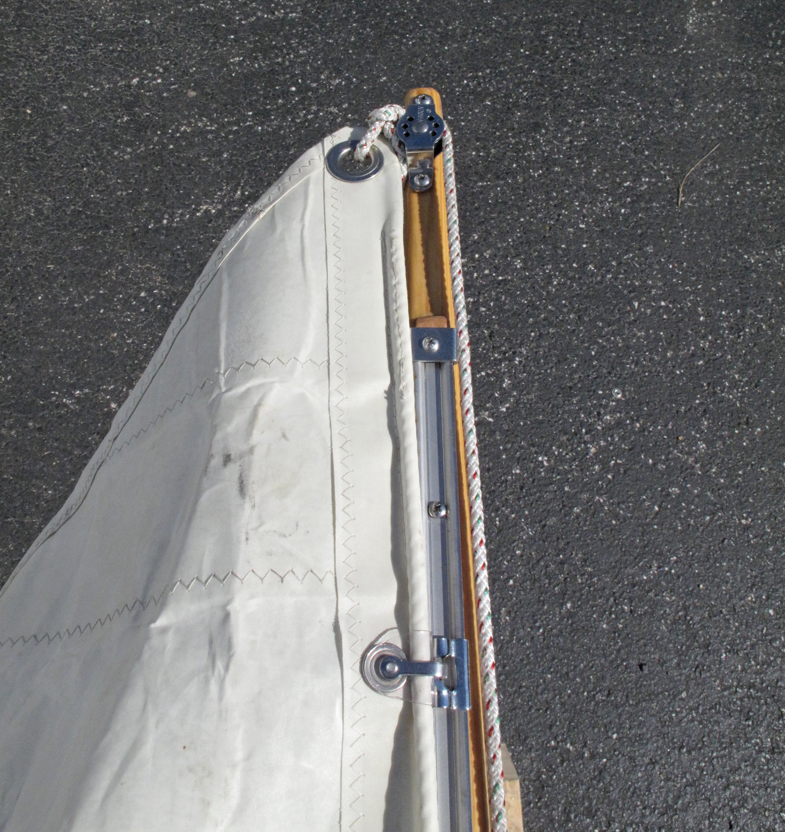 Sail Track installed on a Northeaster Dory Sloop Rig with slider, shackle, stop , and protector.