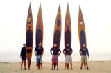 Five surfers  using San-O paddleboards at the beach