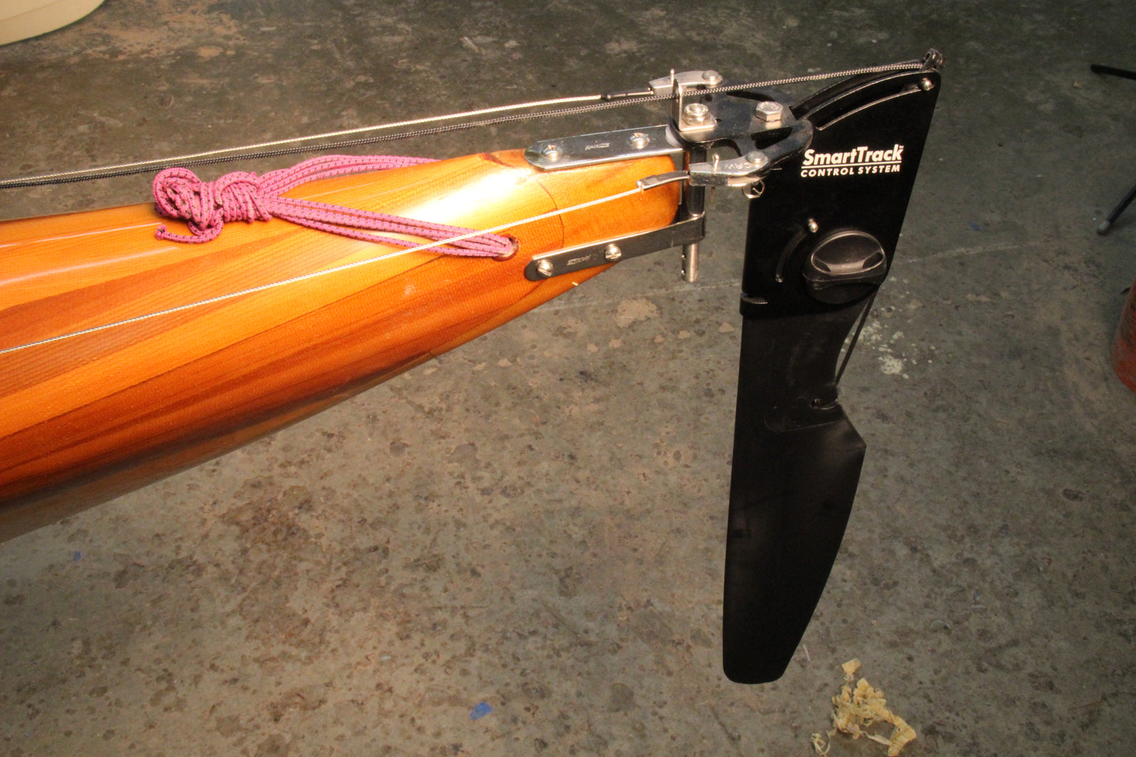 Smart Track Toe Pilot Rudder System being installed on a Guillemot kayak using the V-mount rudder bracket.
