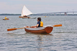 Eastport Ultralight Dinghy with a gunner guard installed, rowing in the Chesapeake Bay. Thumbnail