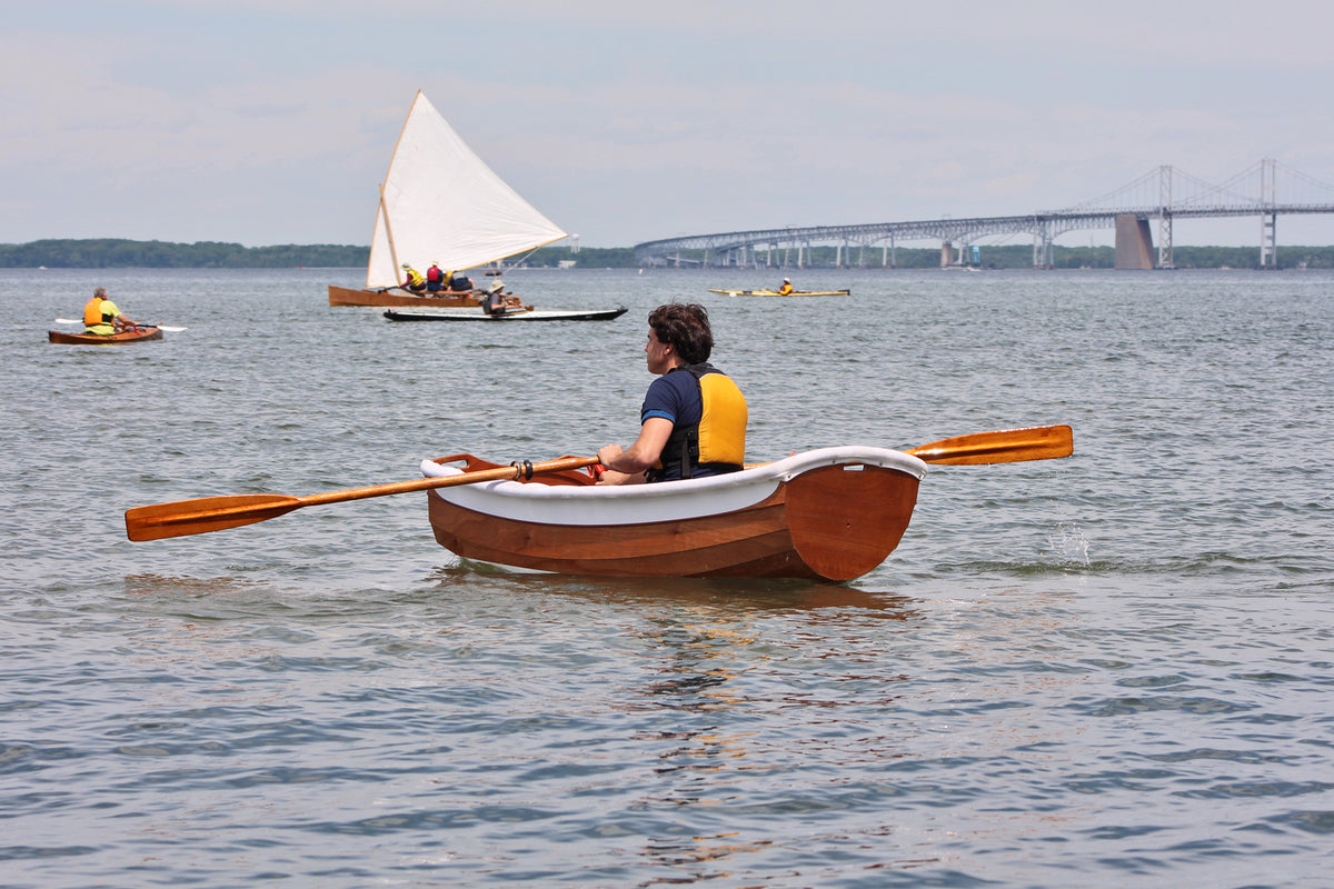 Eastport Ultralight Dinghy with a gunner guard installed, rowing in the Chesapeake Bay.