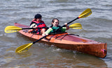 Two avid paddlers in a Wood Duck 14 kayak