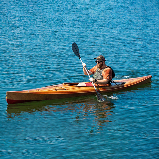 A man paddling a Wood Duck 14 Hybrid kayak